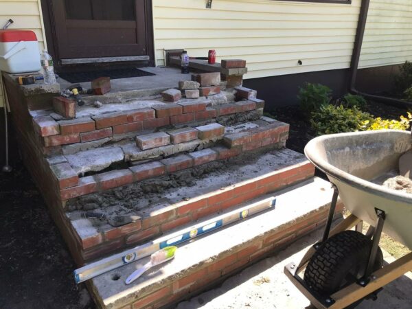 Masons building a new masonry step